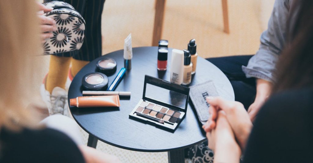 Women gathered around a table applying cosmetics, fostering a collaborative workspace.